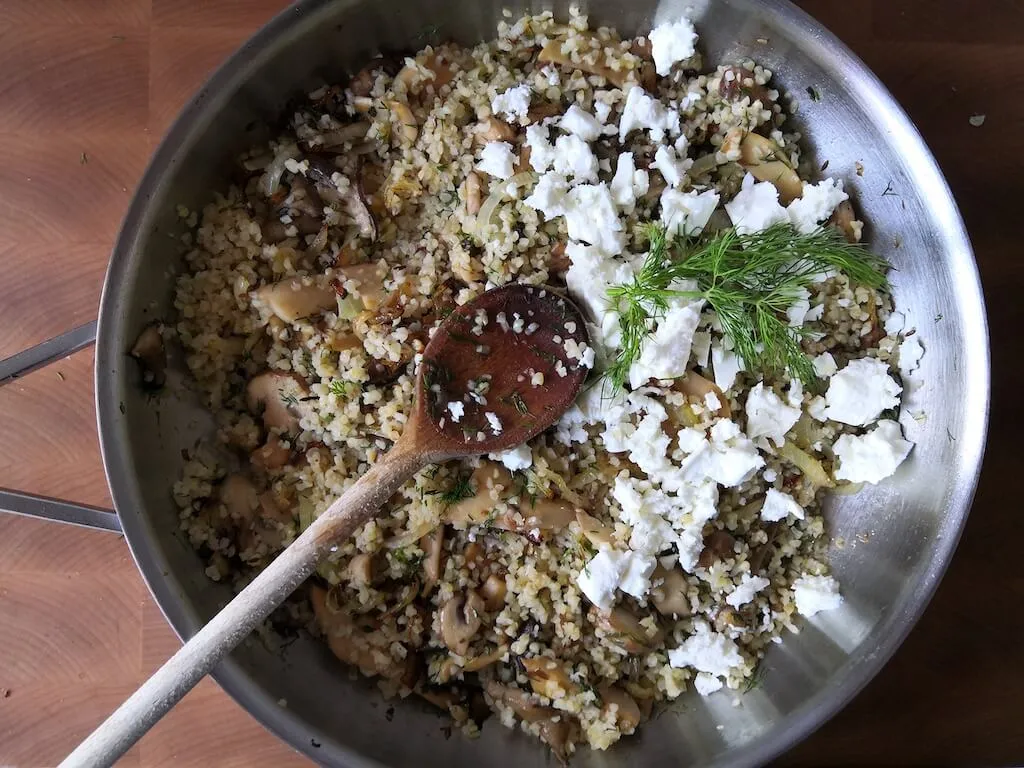 Photo of Tasty bulgur with mushrooms and feta