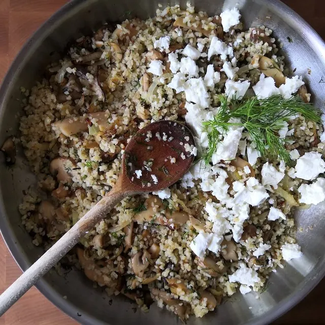 Photo of Tasty bulgur with mushrooms and feta